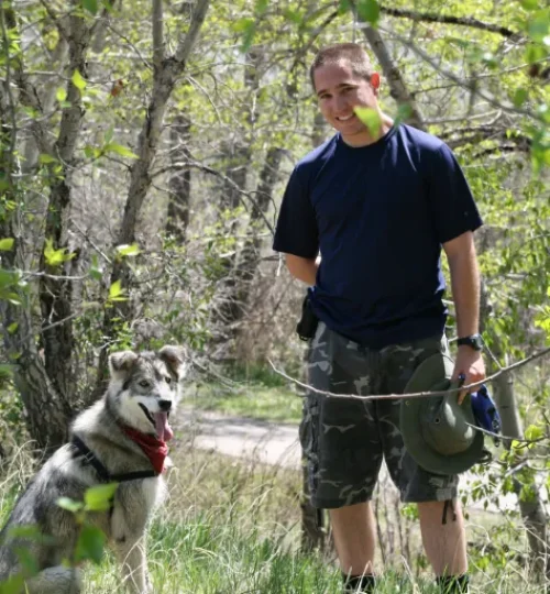 Dog Trainer Tyson Hainsworth and his dog Enzo on a path near Calgary Alberta.